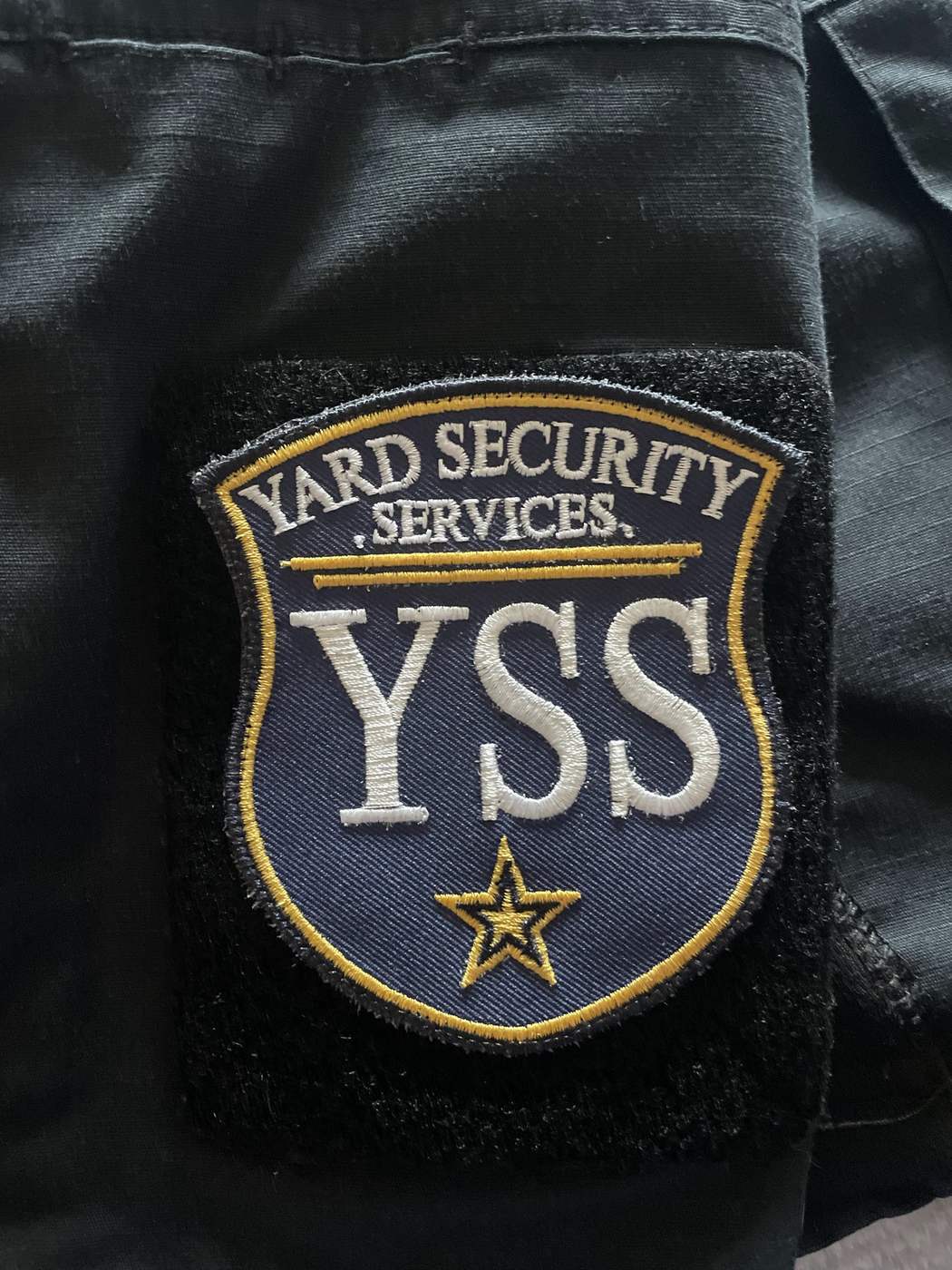 Embroidered YARD Security Services YSS shoulder patch on an officer uniform